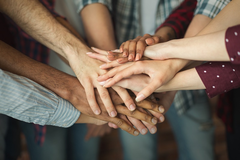 Group of friends holding hands together